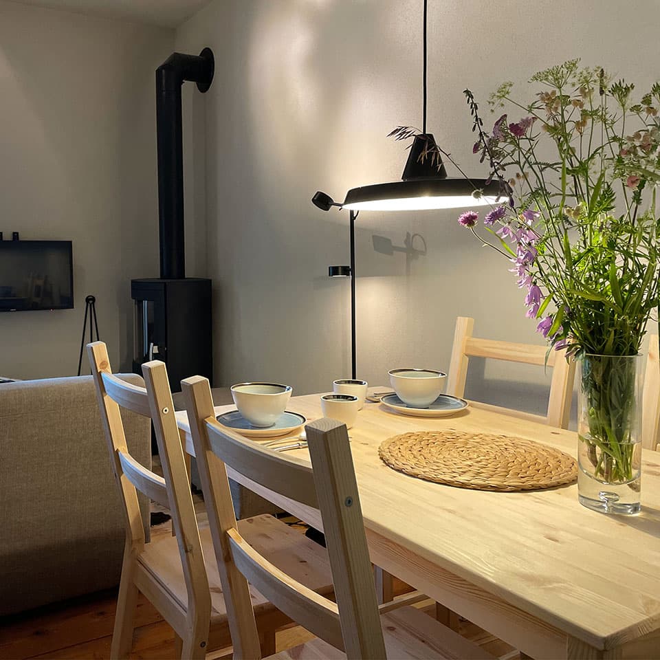 The dining table set for the evening, wildflowers from the meadow