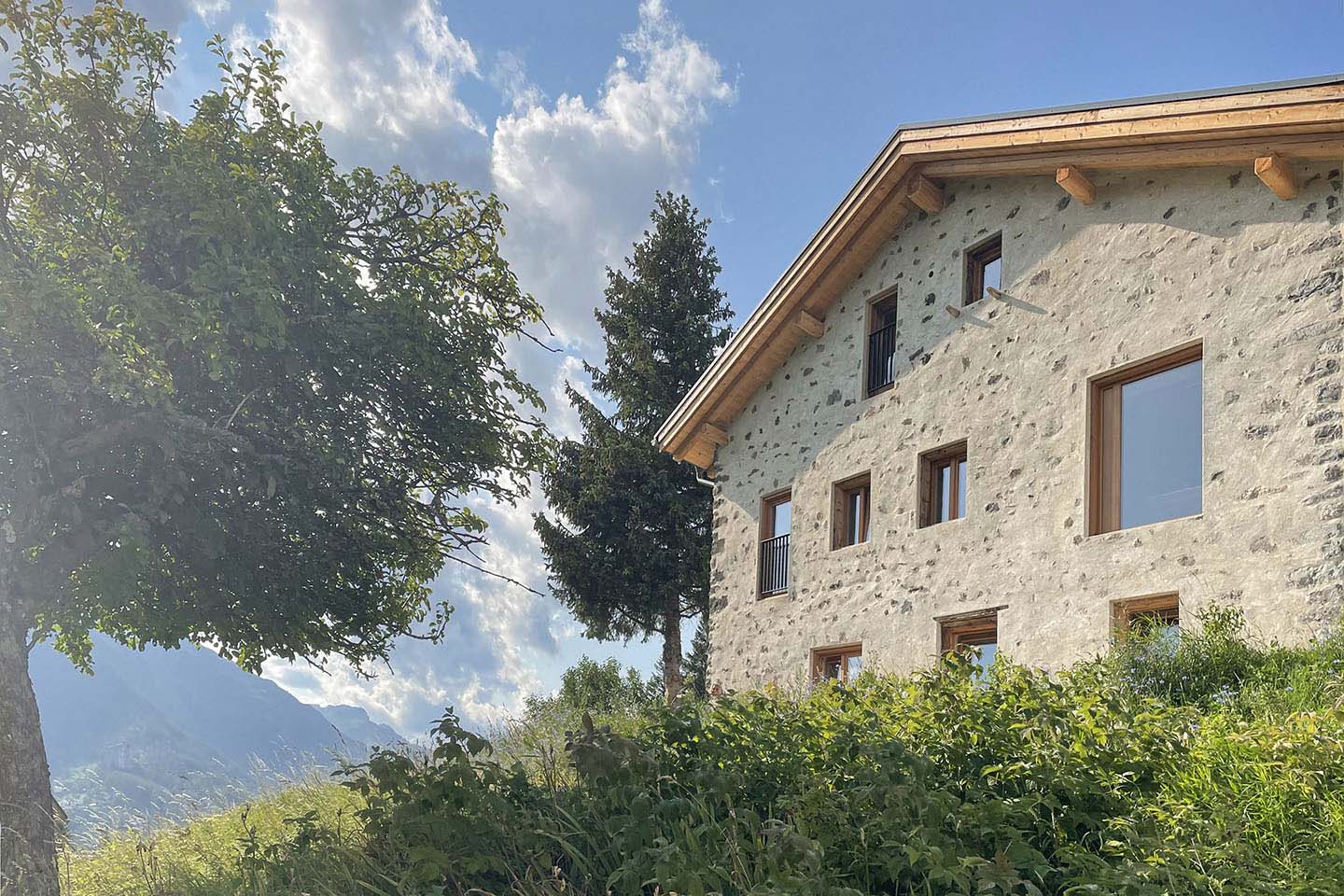 Casa Tie's stone exterior against the mountains
